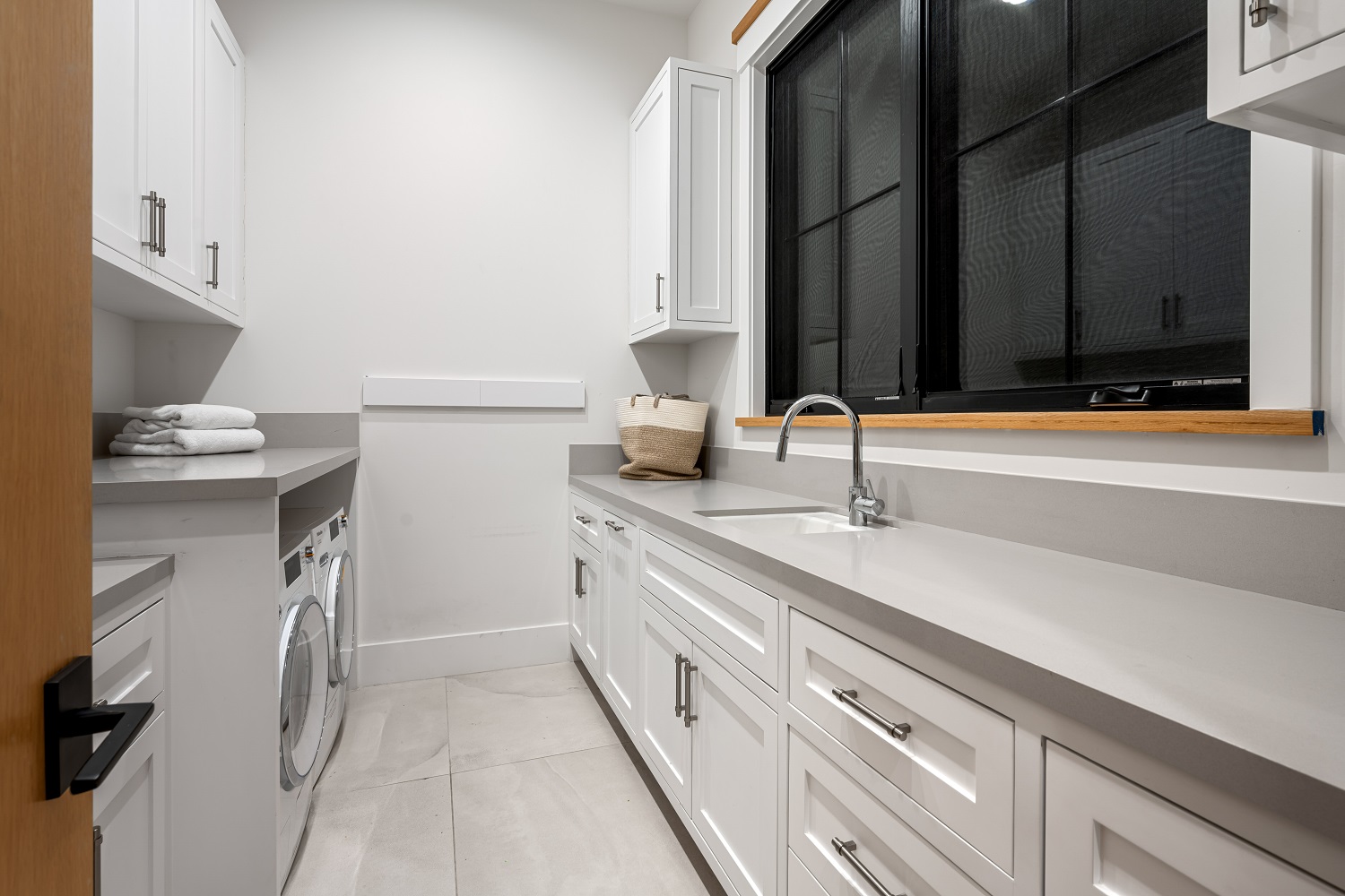 bright-laundry-room-with-white-cabinets-and-counte-2026-03-18-16-14-36-utc